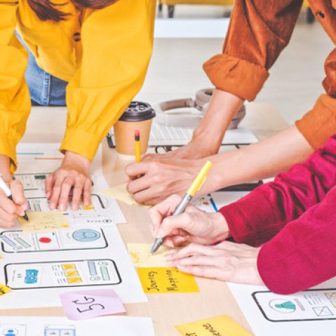 Young Asian business creative team work together, mobile application software design project. Brainstorm meeting, internet technology, smartphone web app designer, office coworker teamwork concept